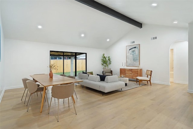 living room featuring lofted ceiling with beams and light wood-type flooring