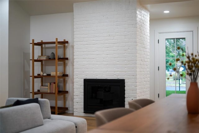 living room with wood-type flooring and a fireplace