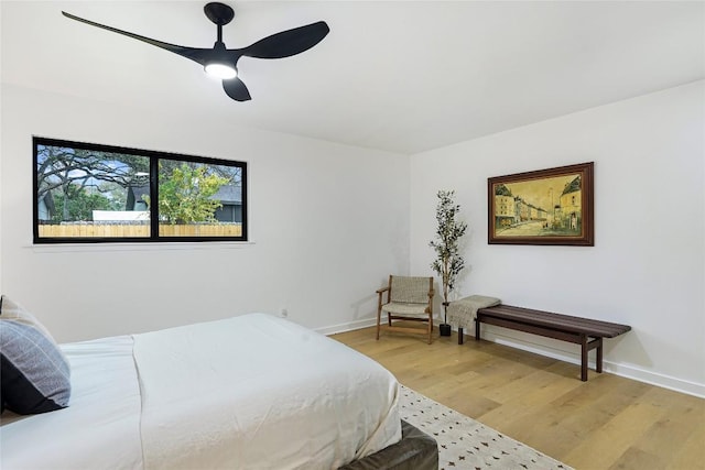 bedroom with hardwood / wood-style flooring and ceiling fan