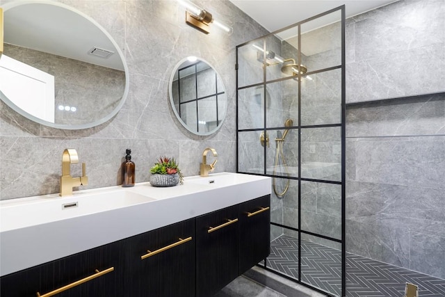 bathroom with vanity, tile walls, backsplash, and a tile shower