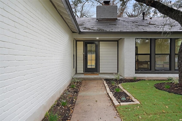 entrance to property with a yard