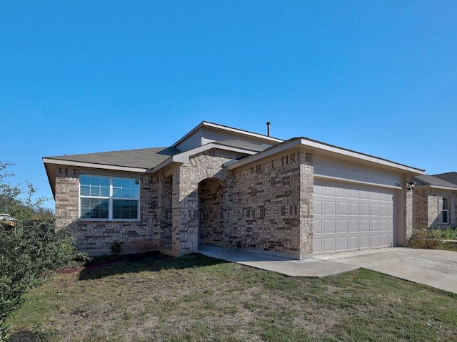 single story home with a garage and a front lawn