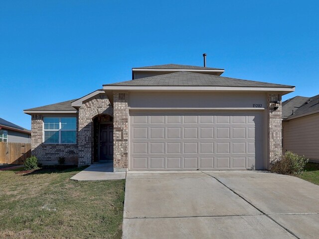 view of front of home featuring a garage and a front yard