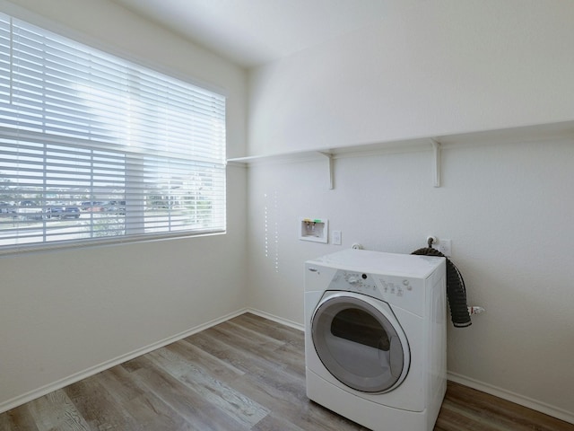 laundry area with washer / dryer and wood-type flooring