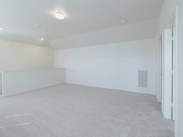 interior space featuring lofted ceiling and light colored carpet