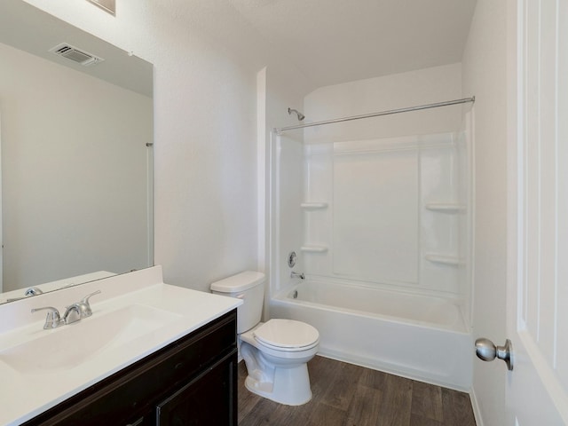 full bathroom featuring vanity, wood-type flooring,  shower combination, and toilet