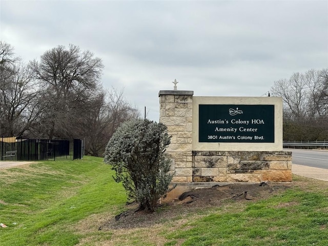 community / neighborhood sign with a lawn