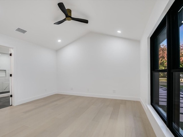 spare room featuring light wood-type flooring, ceiling fan, and lofted ceiling