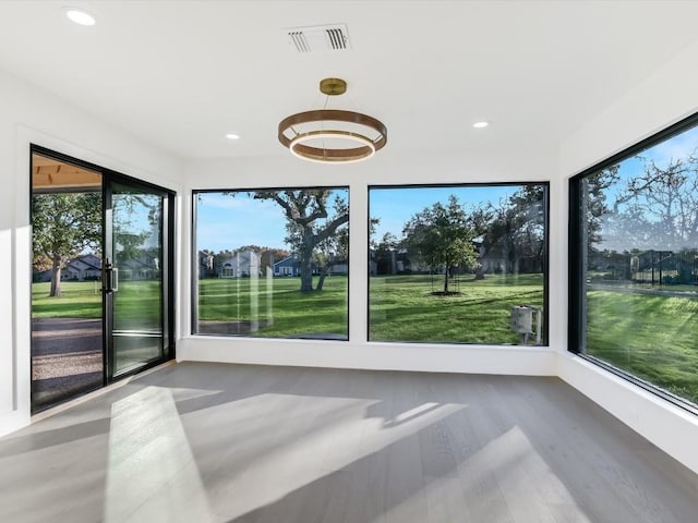 unfurnished sunroom featuring a wealth of natural light