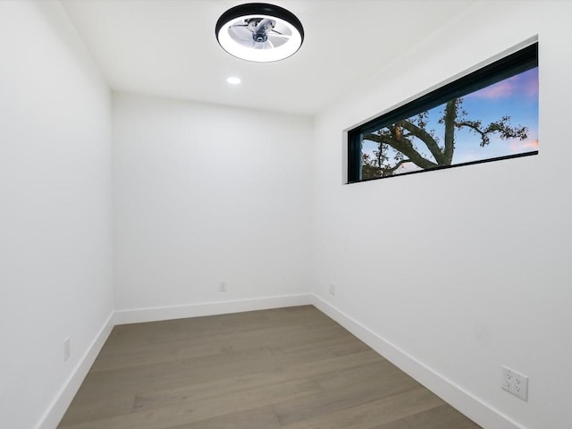 unfurnished room with hardwood / wood-style flooring