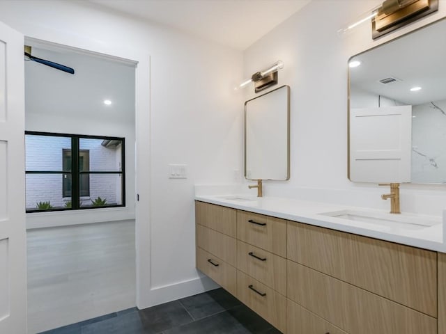 bathroom with ceiling fan, tile patterned flooring, and vanity