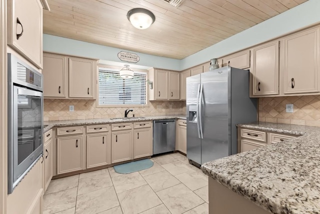 kitchen featuring decorative backsplash, sink, stainless steel appliances, and light stone counters