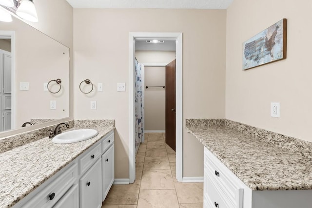 bathroom with tile patterned floors and vanity