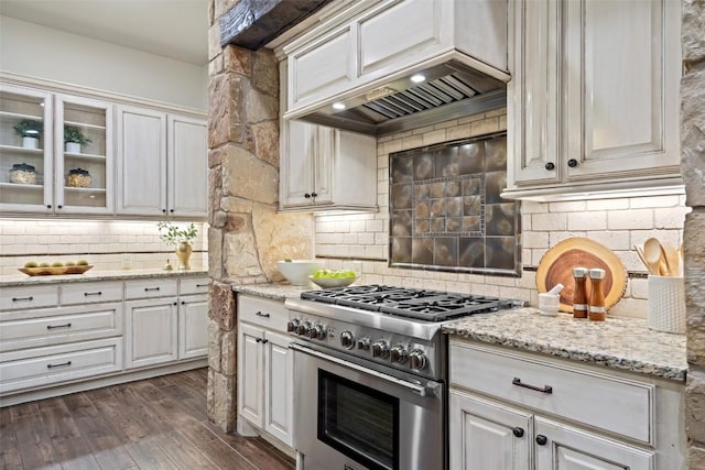 kitchen featuring white cabinetry, dark hardwood / wood-style flooring, backsplash, high end range, and custom range hood