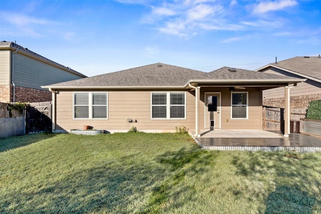 back of property with a yard and a patio