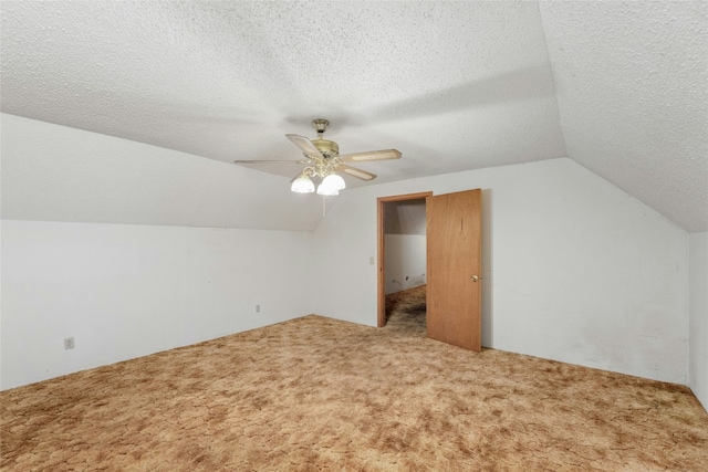 bonus room with carpet floors, ceiling fan, vaulted ceiling, and a textured ceiling