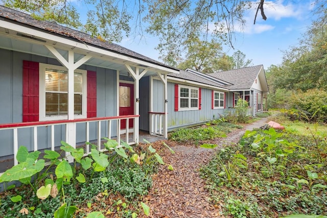20024 W Lakeshore Dr, Magnolia, TX 77355 - view of side of property with board and batten siding, a shingled roof, and a porch
