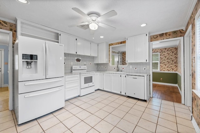 20024 W Lakeshore Dr, Magnolia, TX 77355 - kitchen featuring white appliances, light countertops, white cabinetry, ceiling fan, and wallpapered walls