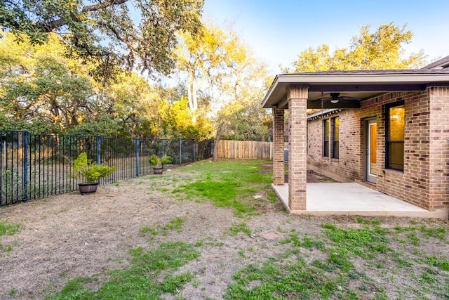 view of yard with a patio area and ceiling fan