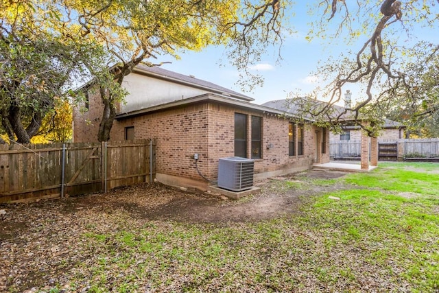 11125 Bastogne Loop, Austin, TX 78739 - back of house featuring brick siding and a fenced backyard