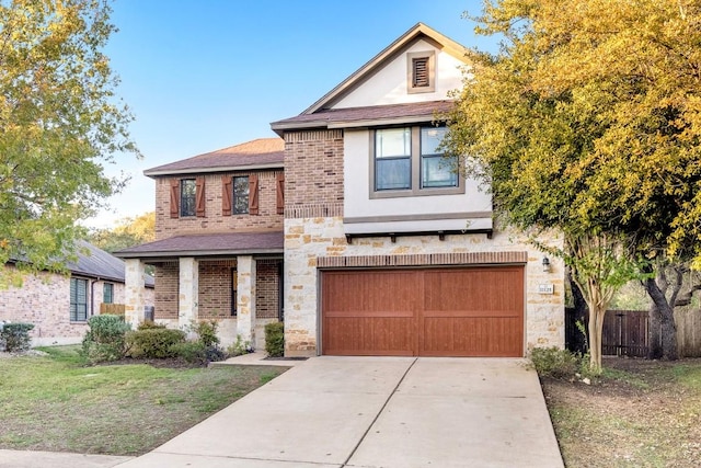 11125 Bastogne Loop, Austin, TX 78739 - view of front facade with driveway, an attached garage, stone siding, brick siding, and stucco siding