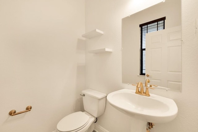 bathroom featuring sink and toilet