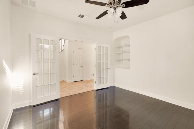 unfurnished room featuring ceiling fan, built in features, french doors, and hardwood / wood-style flooring