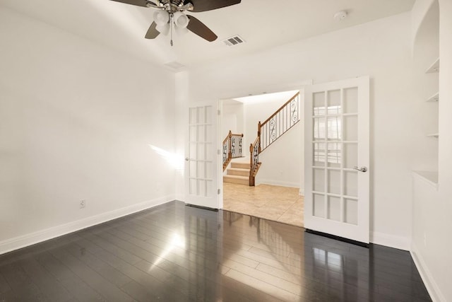 empty room with french doors, ceiling fan, and wood-type flooring