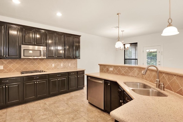 11125 Bastogne Loop, Austin, TX 78739 - kitchen featuring stainless steel appliances, decorative backsplash, pendant lighting, light tile patterned floors, and recessed lighting