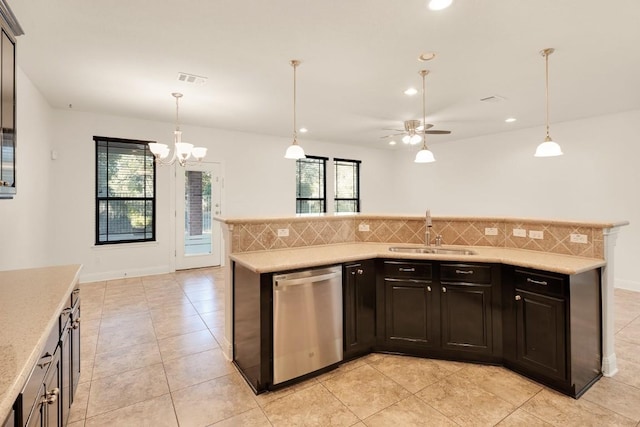 kitchen featuring sink, tasteful backsplash, stainless steel dishwasher, decorative light fixtures, and ceiling fan with notable chandelier