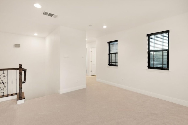 unfurnished room with light colored carpet