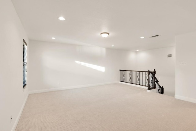 unfurnished room featuring light carpet