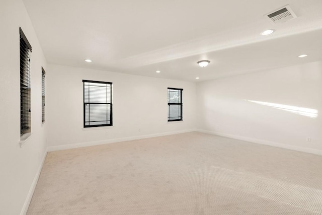 unfurnished room featuring light colored carpet