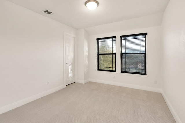 unfurnished room featuring light colored carpet