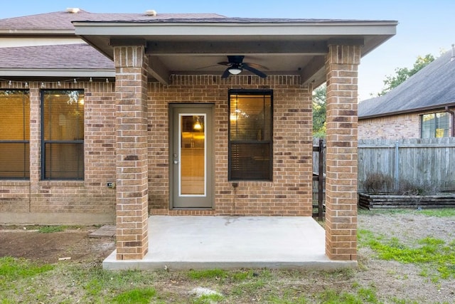 11125 Bastogne Loop, Austin, TX 78739 - property entrance with ceiling fan, brick siding, a patio area, and roof with shingles