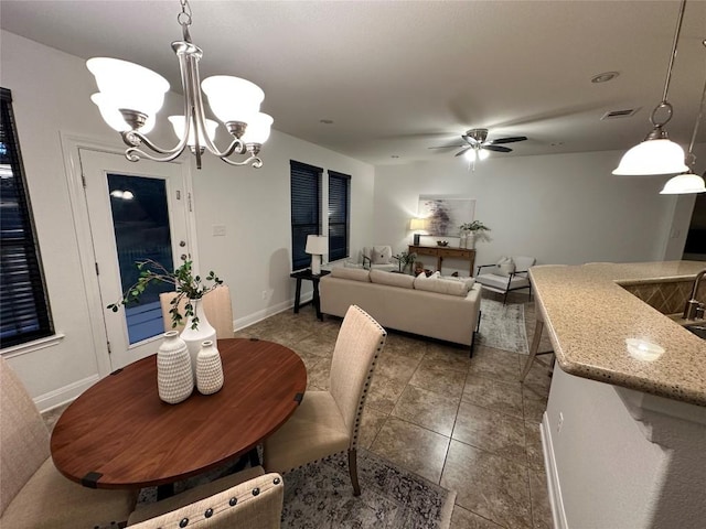 11125 Bastogne Loop, Austin, TX 78739 - dining area with a chandelier, a ceiling fan, and tile patterned flooring