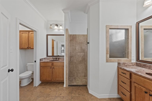 bathroom featuring vanity, tile patterned flooring, toilet, ornamental molding, and a tile shower