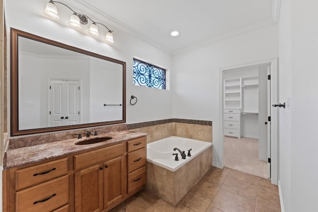 bathroom featuring tile patterned floors, tiled bath, crown molding, and vanity