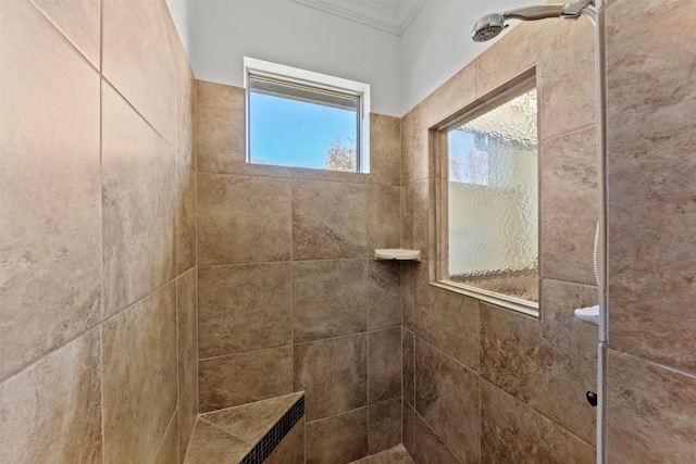 interior details with ornamental molding and tiled shower