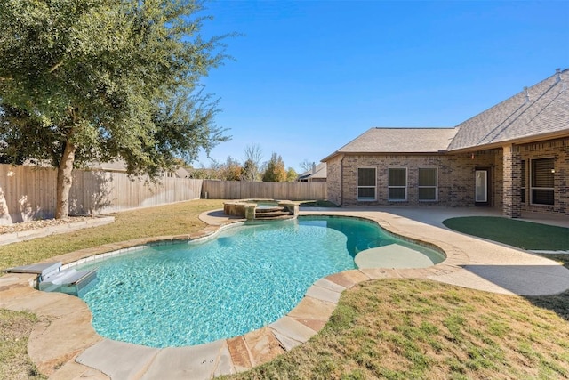 view of swimming pool with an in ground hot tub, a yard, and a patio area