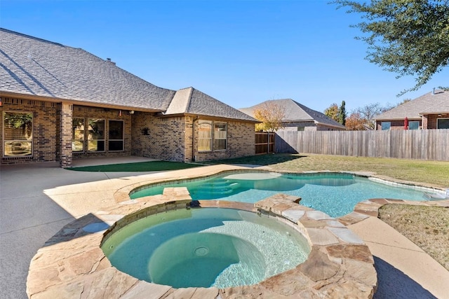 view of pool with a patio area and an in ground hot tub