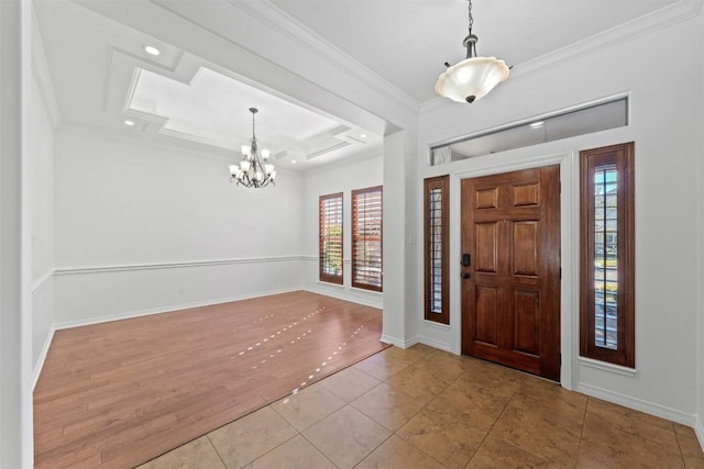 foyer entrance featuring a chandelier, light hardwood / wood-style flooring, and ornamental molding