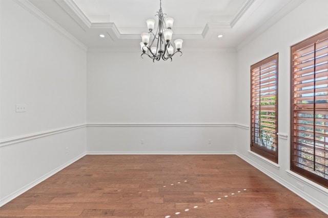 spare room with a tray ceiling, crown molding, plenty of natural light, and hardwood / wood-style floors