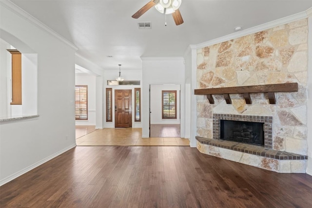 unfurnished living room featuring hardwood / wood-style flooring, ceiling fan, and ornamental molding