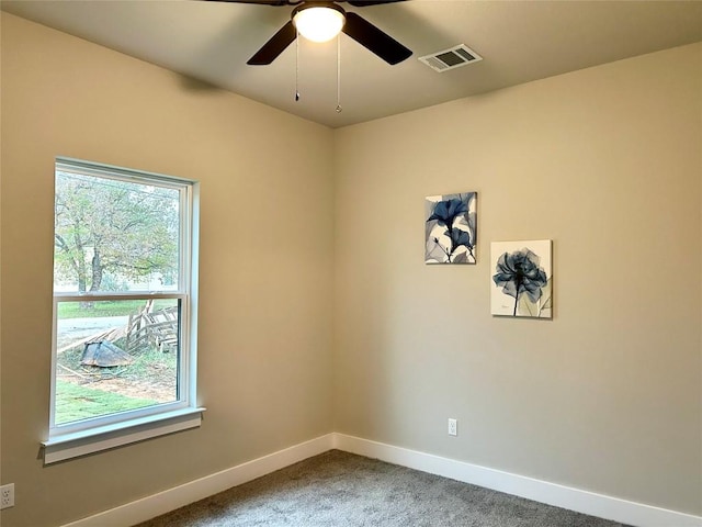 carpeted empty room featuring ceiling fan