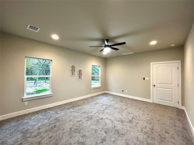 spare room with carpet, ceiling fan, and a healthy amount of sunlight