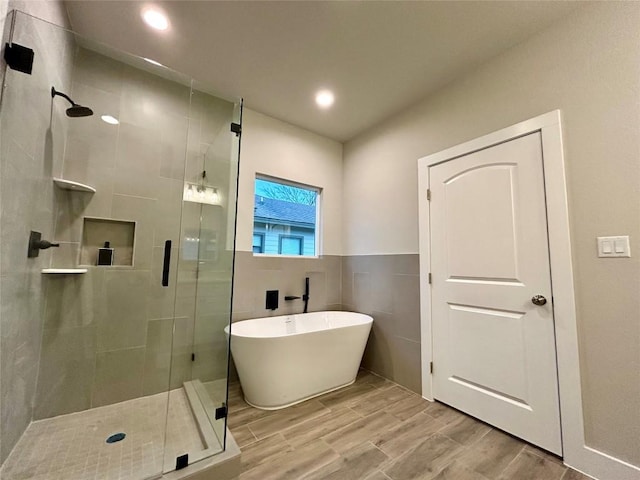 bathroom featuring hardwood / wood-style flooring and independent shower and bath