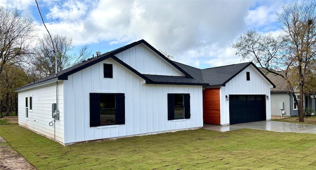 modern farmhouse style home with a front lawn and a garage