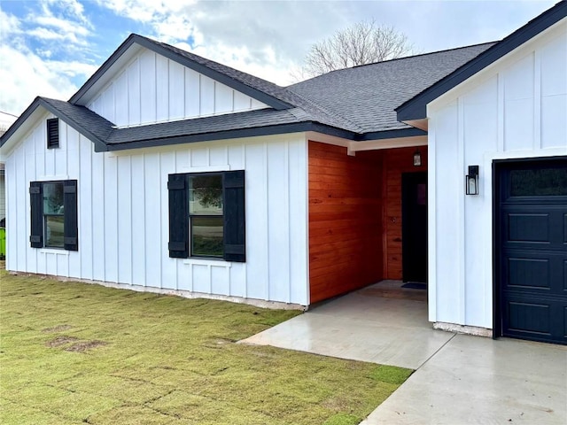 view of side of home with a yard and a garage