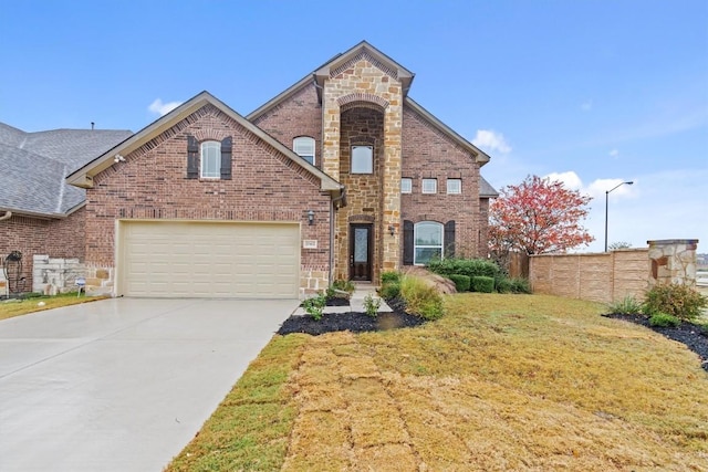 view of property featuring a garage and a front lawn